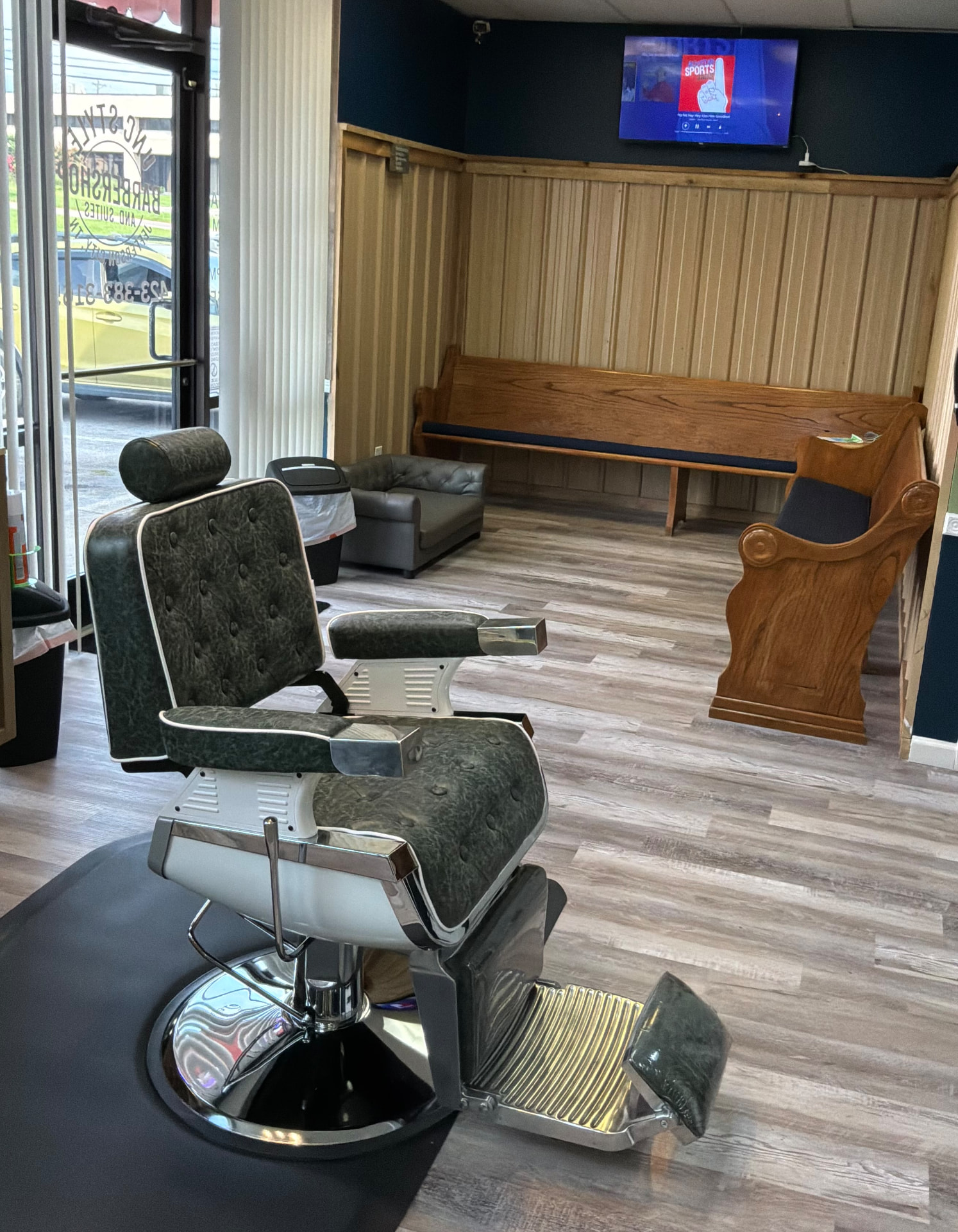 Interior of Unc Style Barbershop and Suites showing barber chair and waiting area